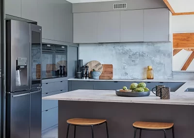 Modern renovated kitchen with sleek handleless cabinetry and stone benchtops