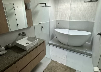 Bathroom renovation with freestanding bath, timber vanity and matte black tapware at Palm Beach