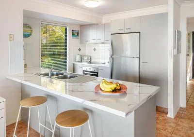 Dated kitchen before apartment renovation at Aspen Place Bilambil Heights