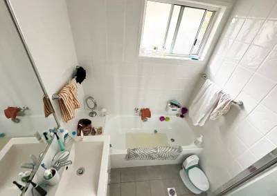 Outdated bathroom fixtures and tiles before renovation in Bilinga Gold Coast