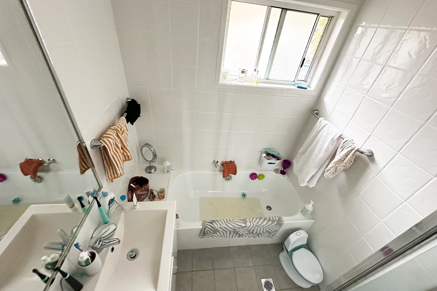 Outdated bathroom fixtures and tiles before renovation in Bilinga Gold Coast