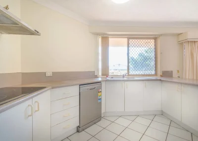 Dated apartment kitchen before renovation at Gold Coast Highway Palm Beach
