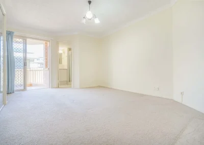 Worn apartment flooring and walls before renovation at Gold Coast Highway Palm Beach