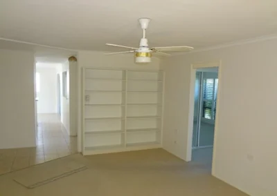 Worn kitchen cabinetry before renovation at Koomooloo Court Mermaid Waters