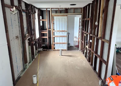 Exposed wall framing and stripped interior during home renovation at Main Beach