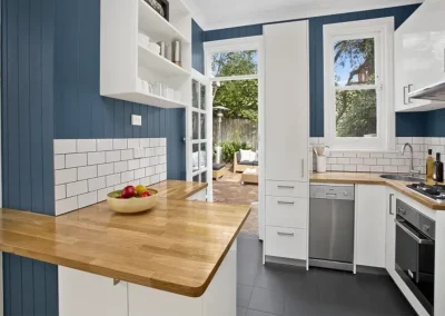 Original kitchen with worn benchtops before renovation in Burleigh Heads