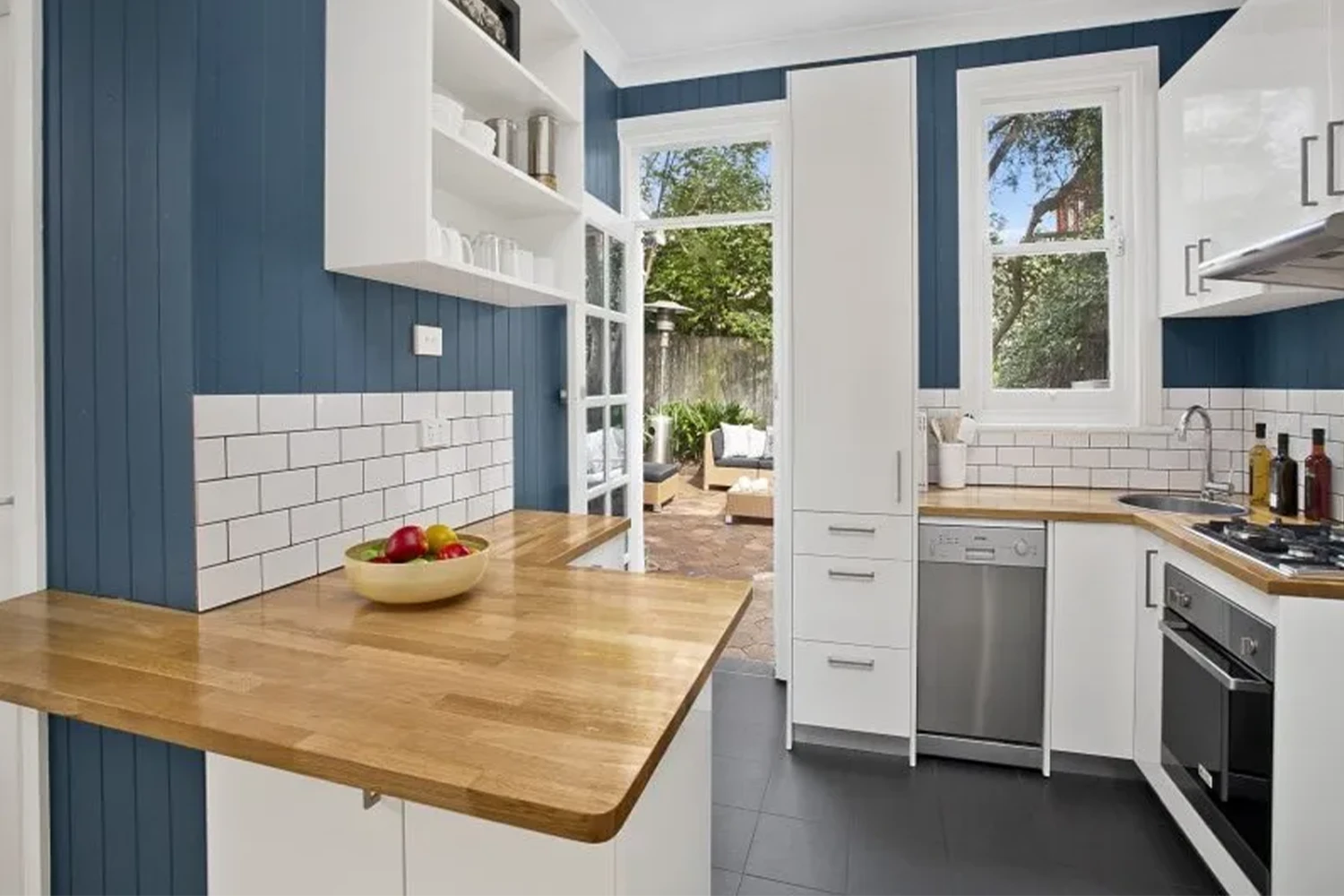Original kitchen with worn benchtops before renovation in Burleigh Heads