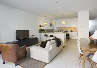 Dated kitchen with old cabinetry and benchtops before renovation in Currumbin