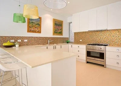 Original kitchen with dated cabinetry and benchtops before renovation in Currumbin
