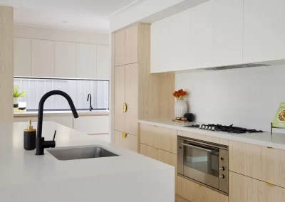 Renovated open-plan kitchen with modern cabinetry and an island bench