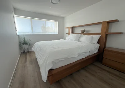 Bedroom renovation with custom timber bedhead, shelving and vinyl plank flooring at Palm Beach