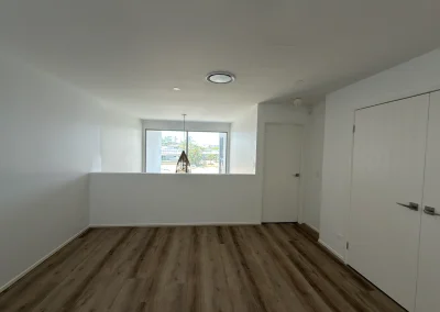 Renovated room with new timber flooring, fresh paint and built-in storage at Palm Beach