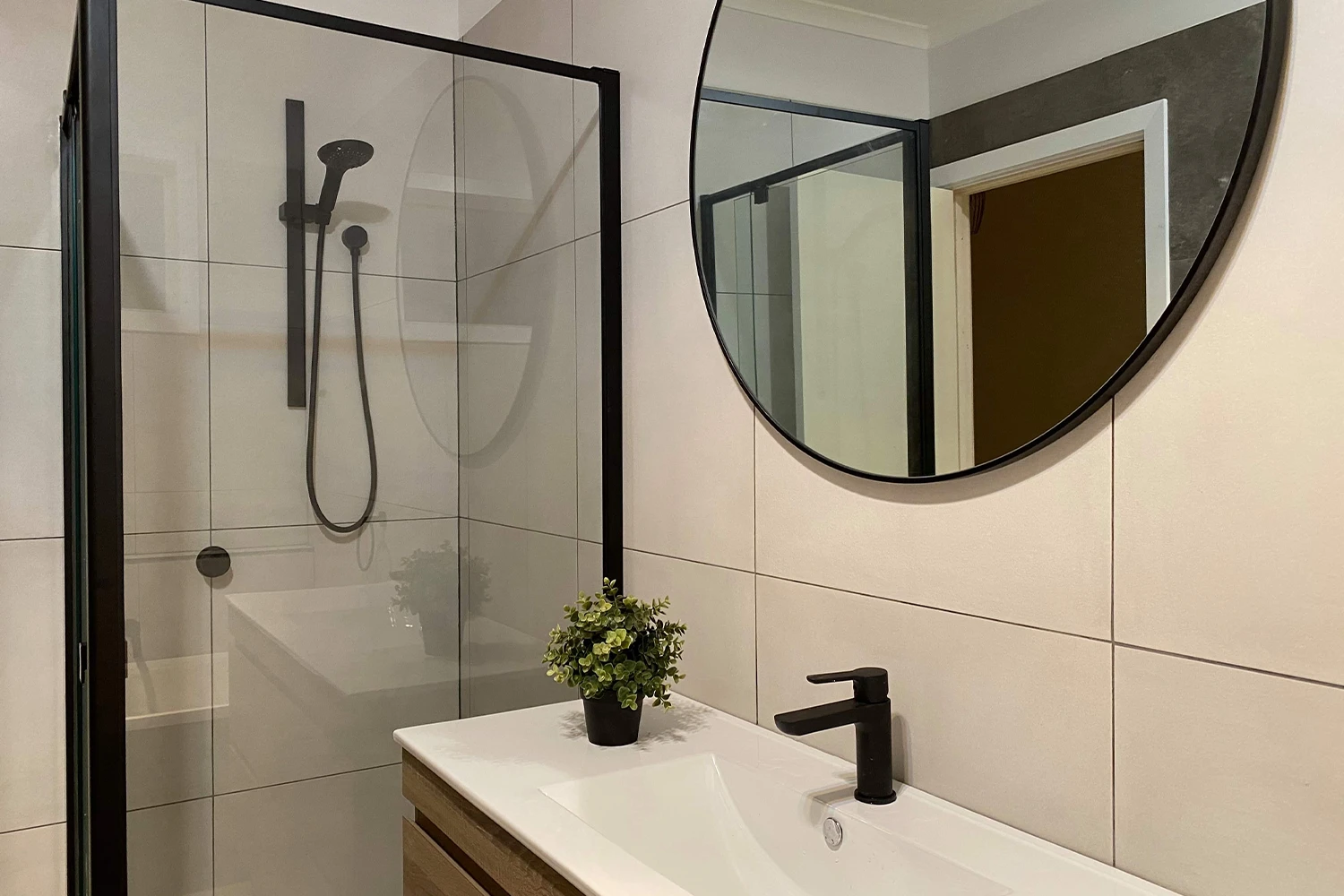 Small bathroom renovation with wall-hung vanity, frameless shower screen and matte black tapware, Palm Beach Gold Coast