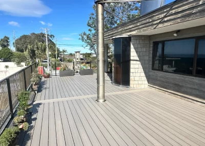 New composite deck extending along house with outdoor entertaining space in Currumbin
