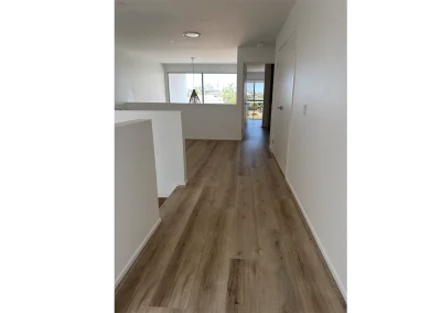 New timber-look vinyl plank flooring installed throughout renovated home at Palm Beach